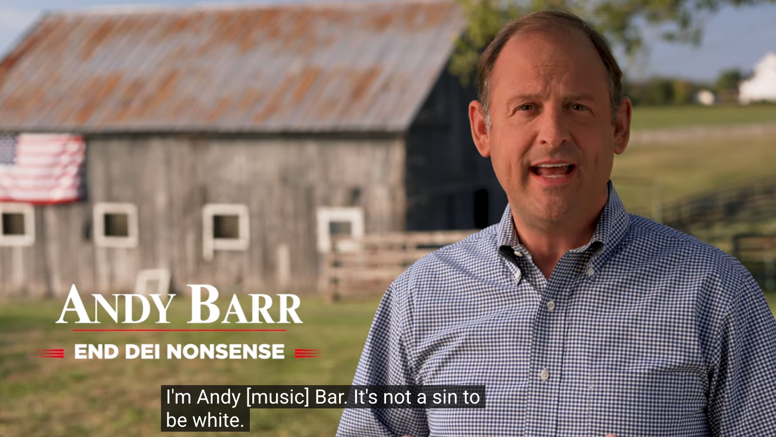 Andy Barr stands in front of a farmhouse with an American flag on it. There’s text overlaid that says “Andy Barr / End DEI nonsense”, and subtitles read: “I’m Andy [music] Bar. It’s not a sin to be white.”