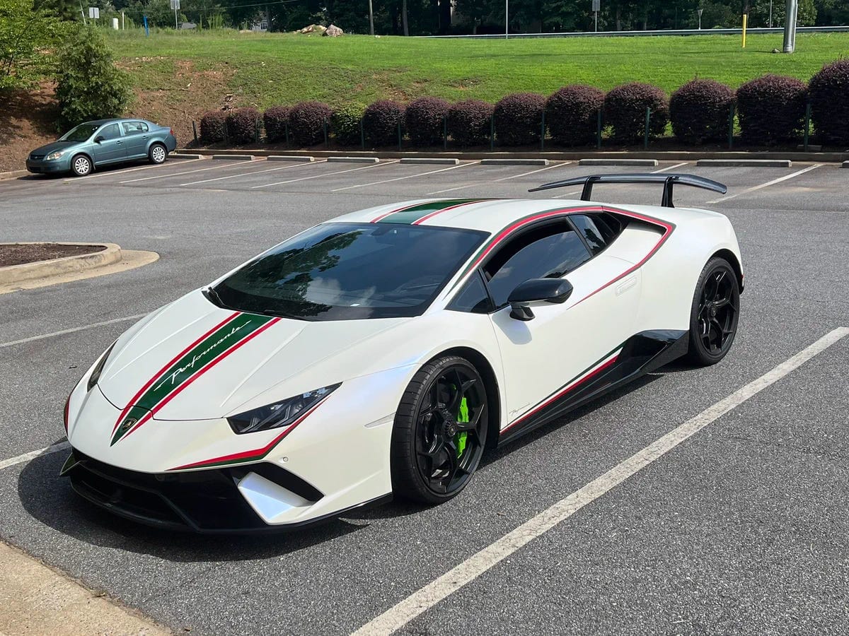 A white Lamborghini with red and black trim