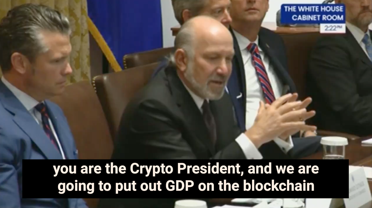 Howard Lutnick speaking at a Cabinet meeting, with subtitles about putting “GDP on the blockchain”