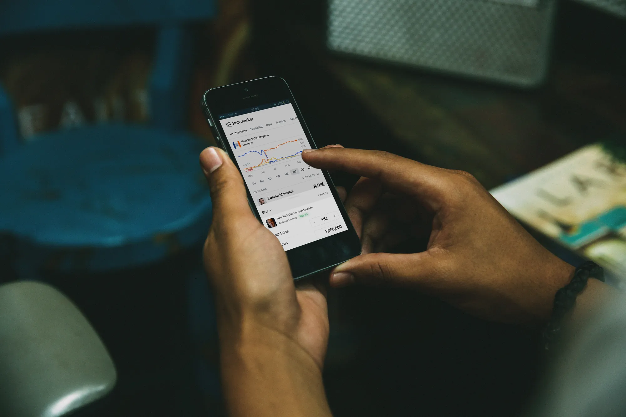 A person uses their phone to place a bet on a Polymarket market on the NYC mayoral race