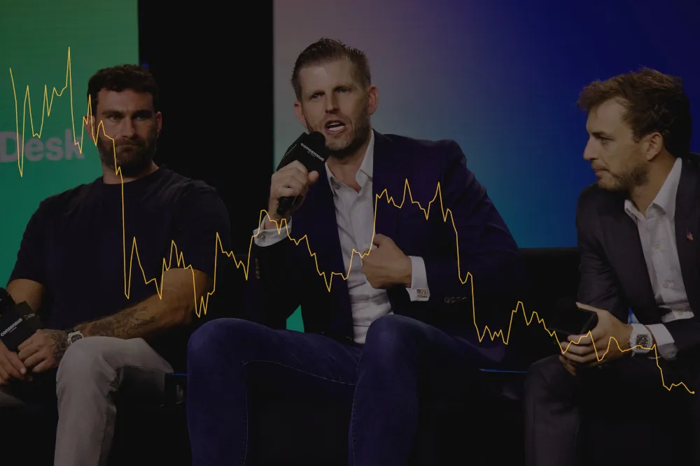 Zak Folkman, Eric Trump, and Zachary Witkoff speak onstage at a conference. Superimposed is the price chart for WLFI, which has dramatically gone down.