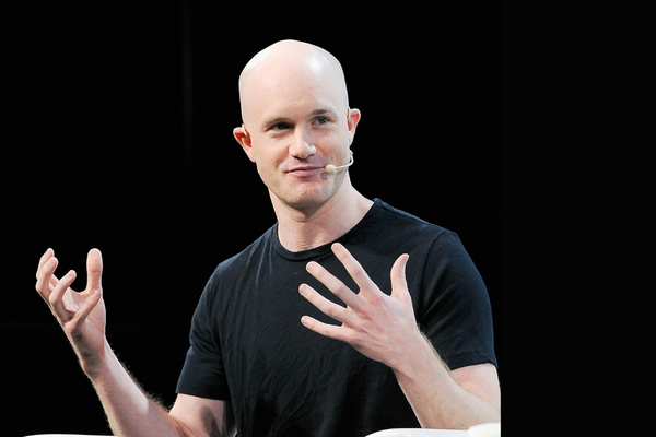 Coinbase CEO Brian Armstrong gestures with his hands in front of him