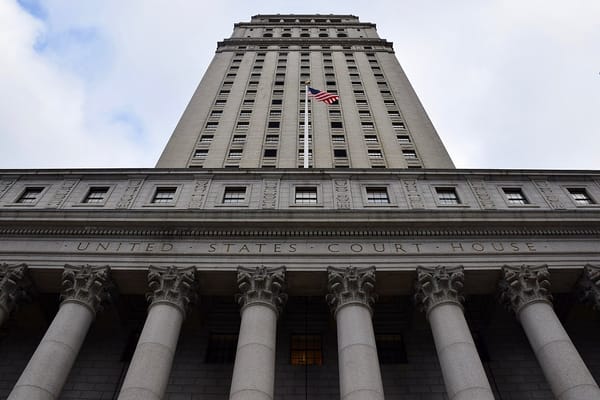 A photograph of the Thurgood Marshall Courthouse in New York, taken from below and looking up