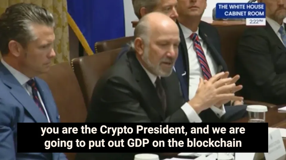 Howard Lutnick speaking at a Cabinet meeting, with subtitles about putting “GDP on the blockchain”